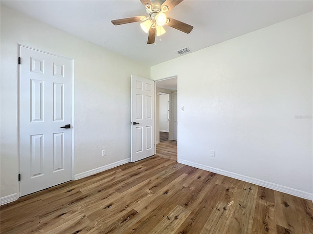 unfurnished bedroom featuring wood-type flooring and ceiling fan