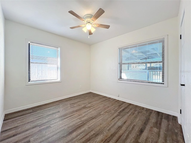 spare room featuring ceiling fan and dark wood-type flooring