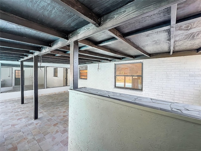 basement featuring brick wall