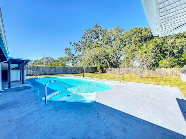 view of pool featuring a lawn and a patio