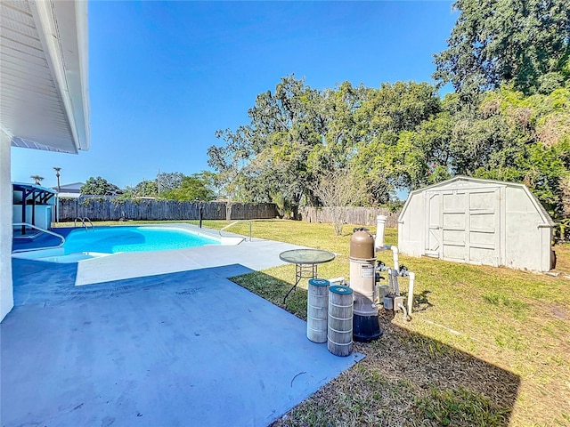 view of swimming pool featuring a yard, a patio, and a storage unit