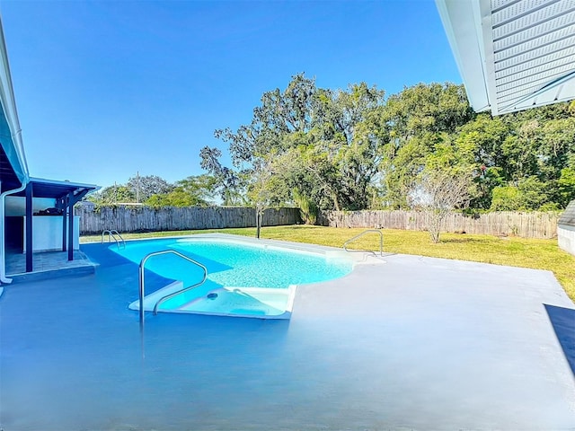 view of swimming pool with a lawn and a patio