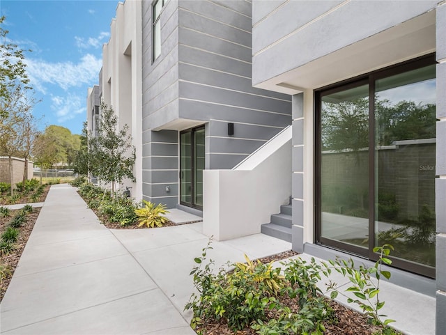 view of exterior entry with a patio