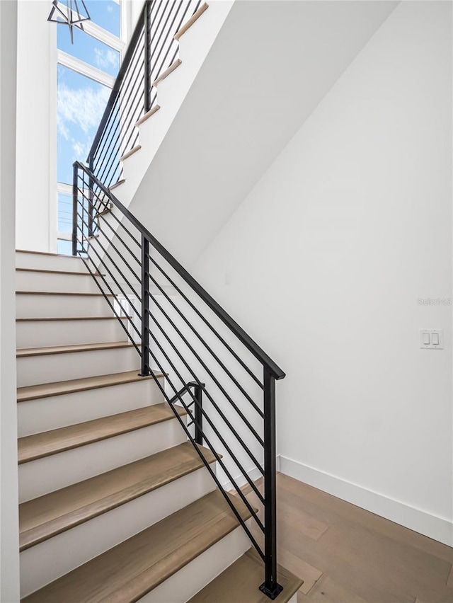 stairs with hardwood / wood-style floors