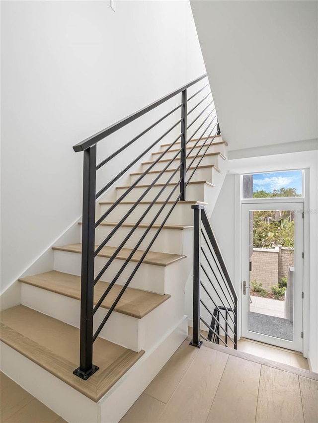 stairs featuring hardwood / wood-style floors