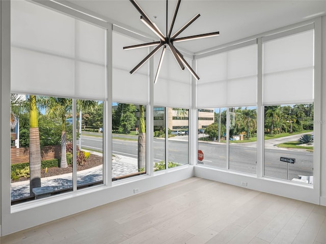 unfurnished sunroom with a chandelier