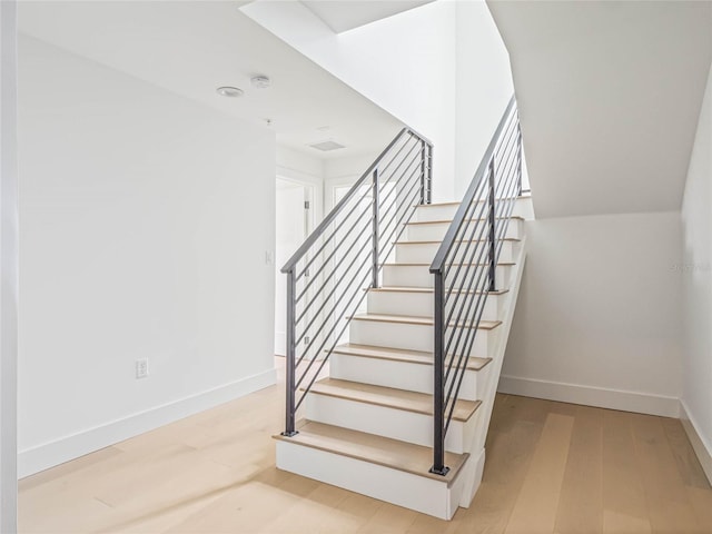 stairs featuring hardwood / wood-style flooring