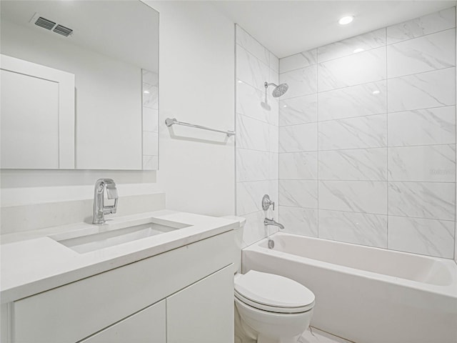 full bathroom with vanity, tiled shower / bath combo, and toilet