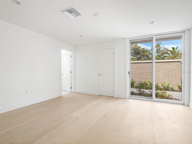 unfurnished room with light hardwood / wood-style flooring