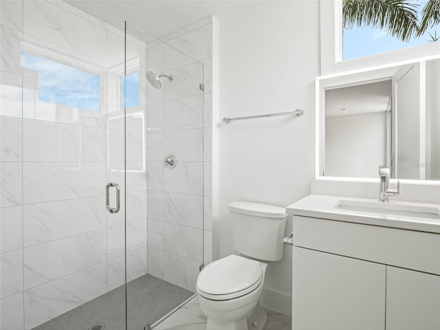 bathroom featuring vanity, toilet, and a shower with shower door