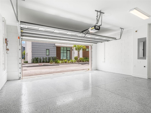 garage with electric panel and a garage door opener