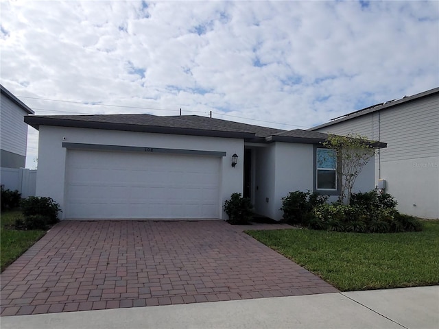 single story home with a garage and a front yard