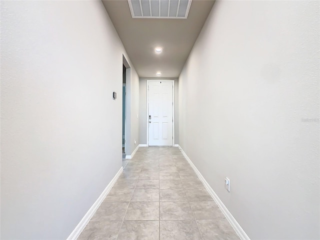 hall with light tile patterned floors