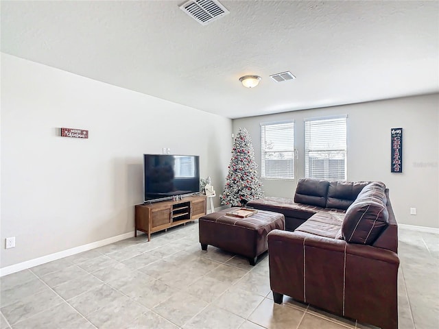 living room with light tile patterned floors and a textured ceiling