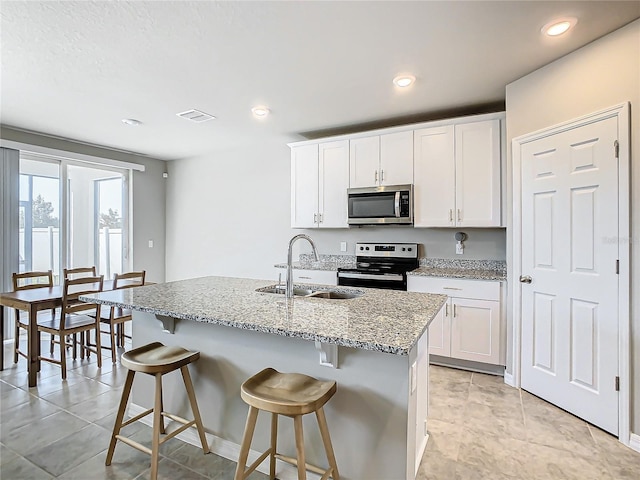 kitchen with white cabinets, stainless steel appliances, and sink