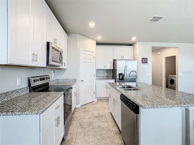 kitchen featuring white cabinetry, sink, stainless steel appliances, washer / clothes dryer, and a center island with sink