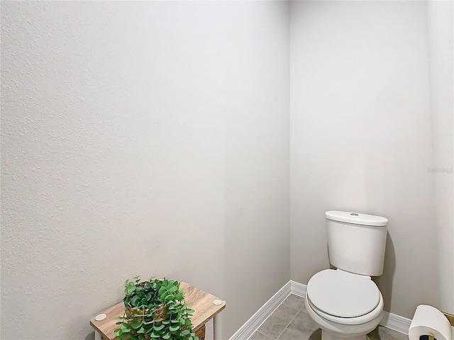 bathroom with tile patterned floors and toilet