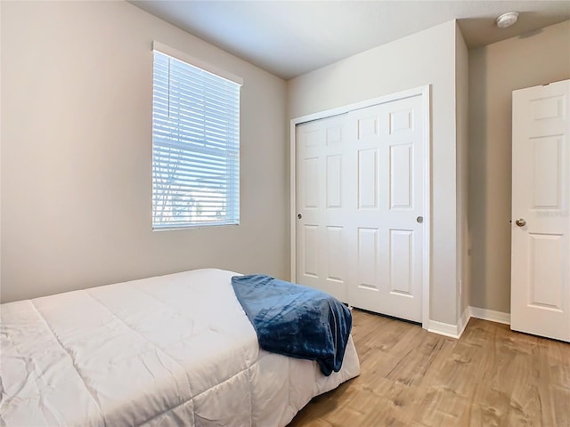 bedroom with a closet and light wood-type flooring