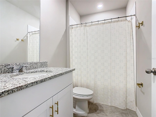 bathroom featuring tile patterned flooring, vanity, and toilet