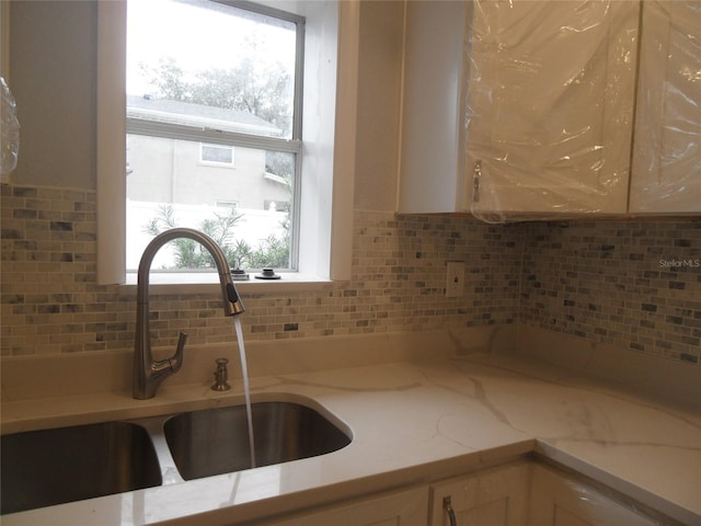 kitchen featuring decorative backsplash and sink