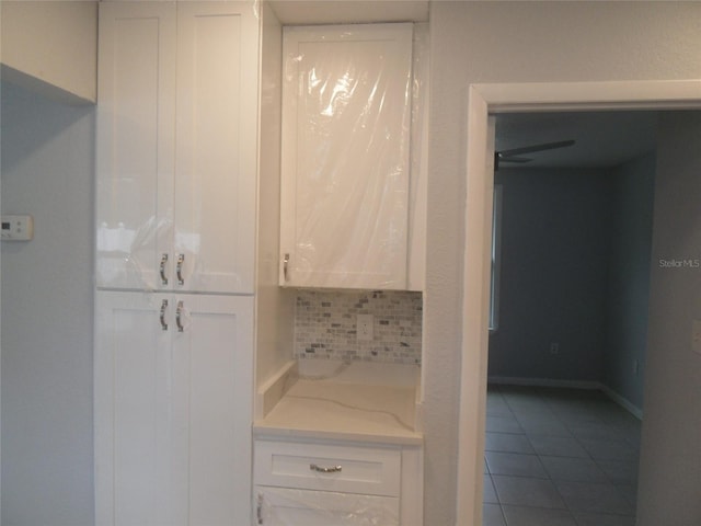 bathroom featuring decorative backsplash and tile patterned flooring