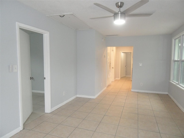 tiled empty room with ceiling fan