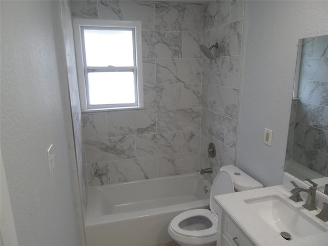 full bathroom with toilet, vanity, and tiled shower / bath