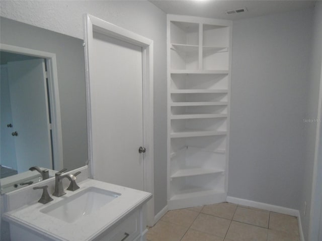 bathroom with tile patterned flooring and vanity