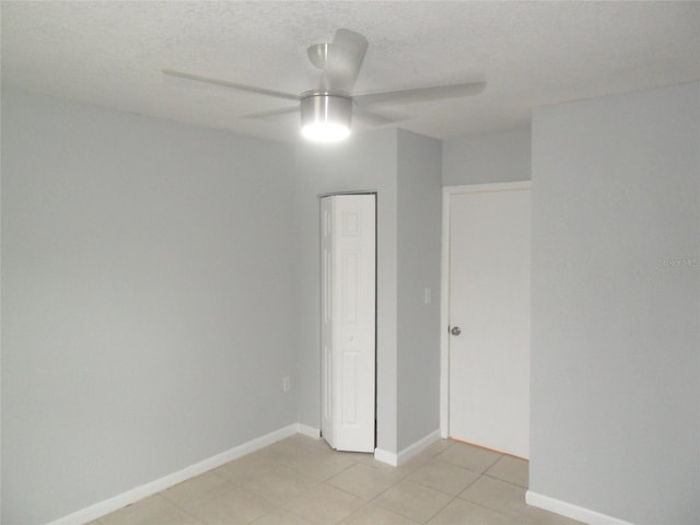 unfurnished bedroom with ceiling fan and a textured ceiling