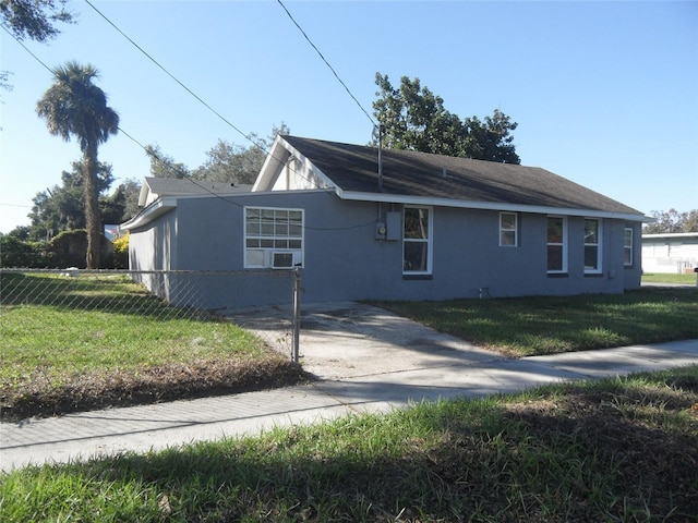 view of side of home with a yard and cooling unit