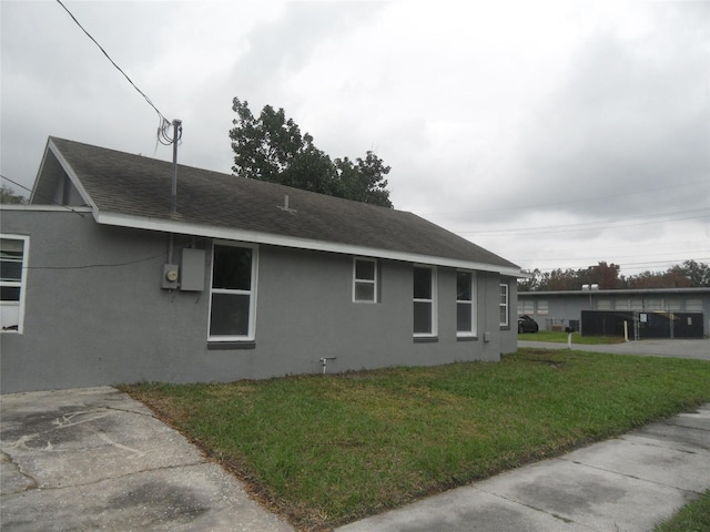 view of side of home with a lawn