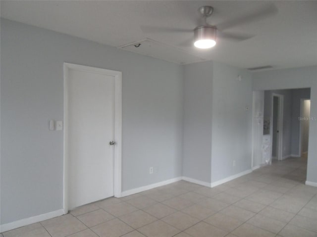 tiled empty room with ceiling fan