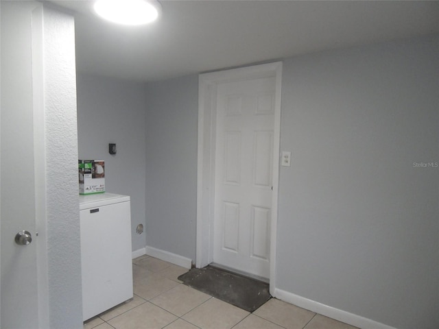 clothes washing area featuring light tile patterned flooring