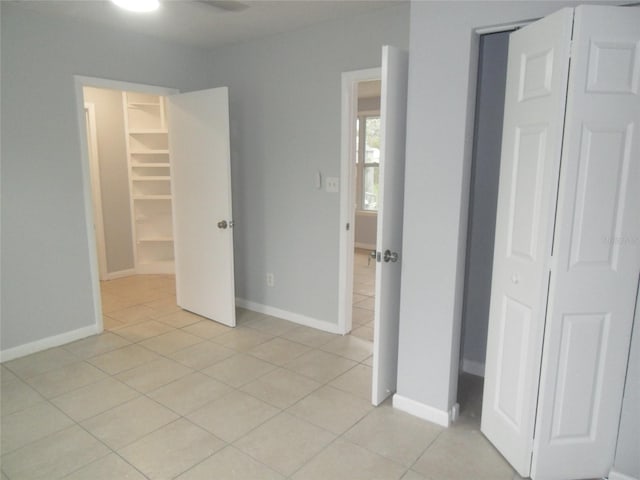 unfurnished bedroom featuring a closet and light tile patterned floors