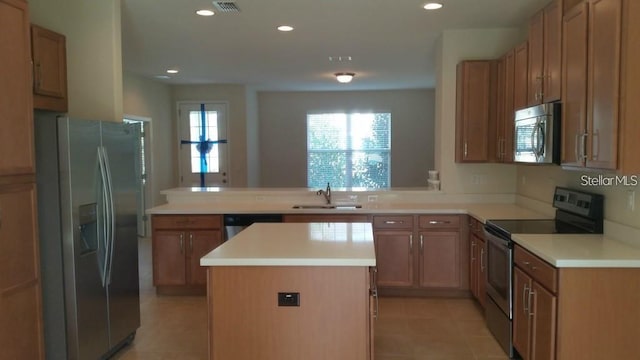 kitchen featuring a center island, sink, stainless steel appliances, kitchen peninsula, and light tile patterned flooring