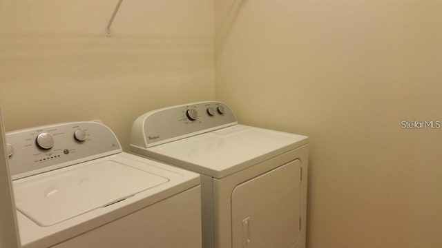 clothes washing area with separate washer and dryer