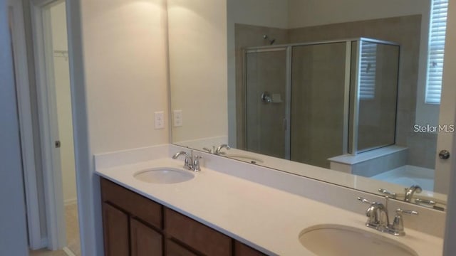 bathroom with vanity and a shower with shower door