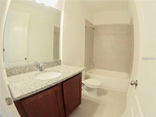 full bathroom featuring tile patterned floors, vanity, toilet, and tiled shower / bath combo