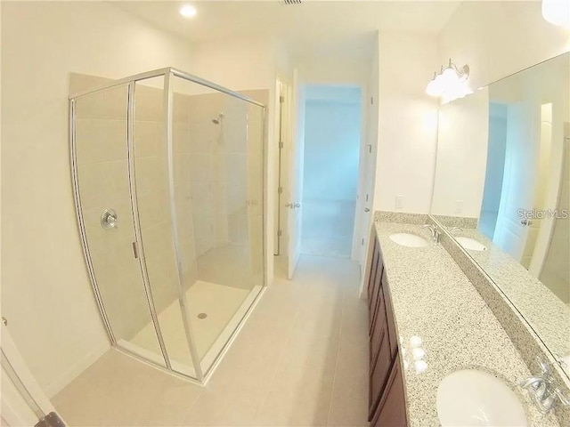 bathroom featuring vanity and a shower with shower door