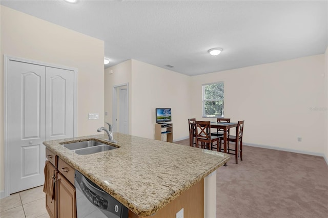 kitchen with a kitchen island with sink, sink, light colored carpet, and stainless steel dishwasher