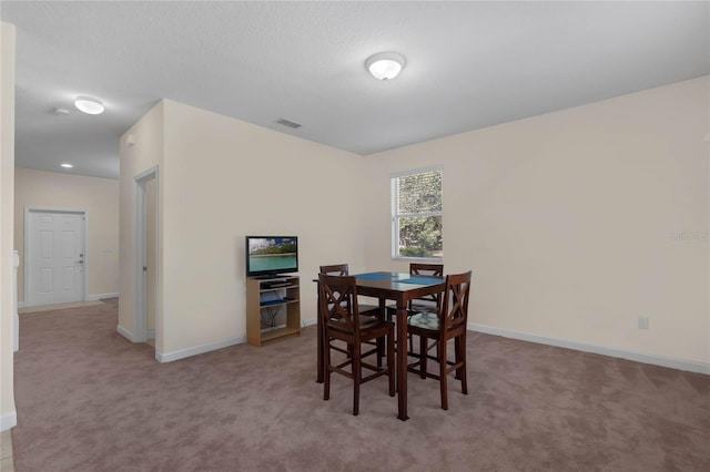 dining room featuring light colored carpet