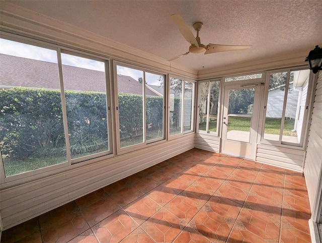 unfurnished sunroom with ceiling fan