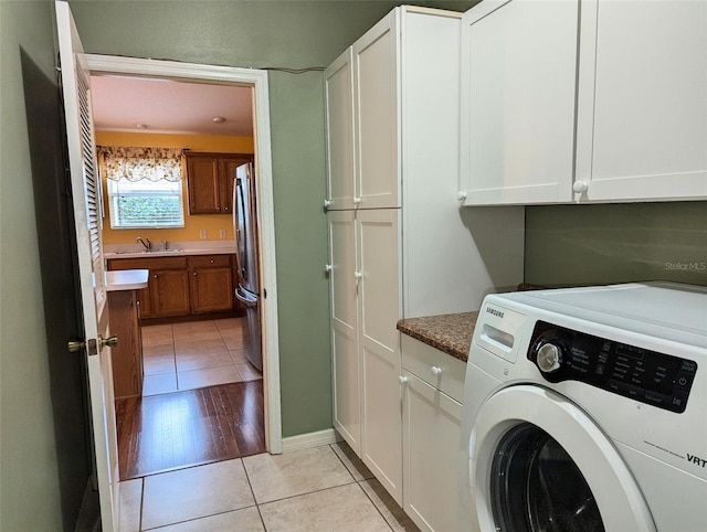 washroom with sink, cabinets, and light hardwood / wood-style floors