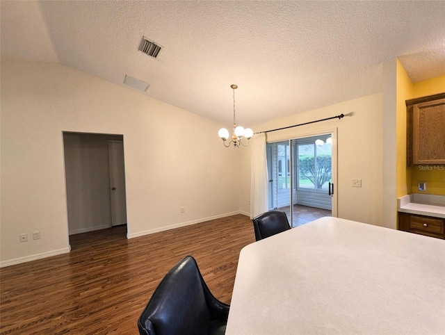 bedroom featuring lofted ceiling, access to outside, dark hardwood / wood-style floors, a textured ceiling, and a notable chandelier