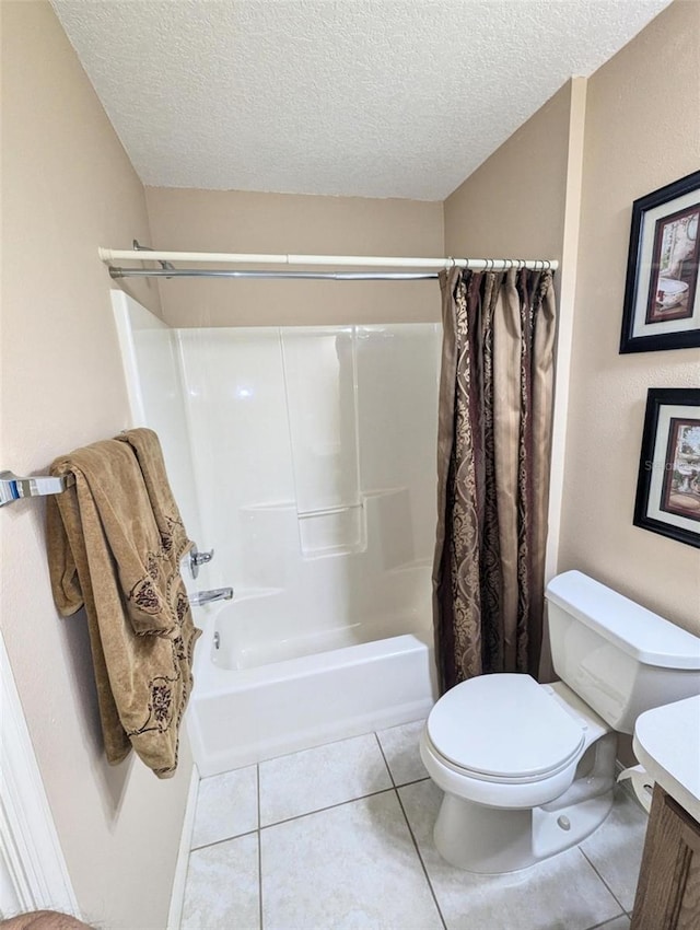 full bathroom featuring tile patterned flooring, a textured ceiling, toilet, shower / bath combo with shower curtain, and vanity