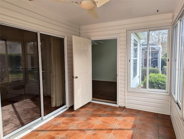 unfurnished sunroom with ceiling fan