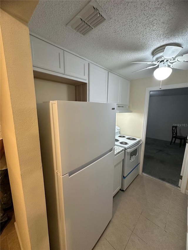 kitchen featuring a textured ceiling, white appliances, white cabinetry, and exhaust hood