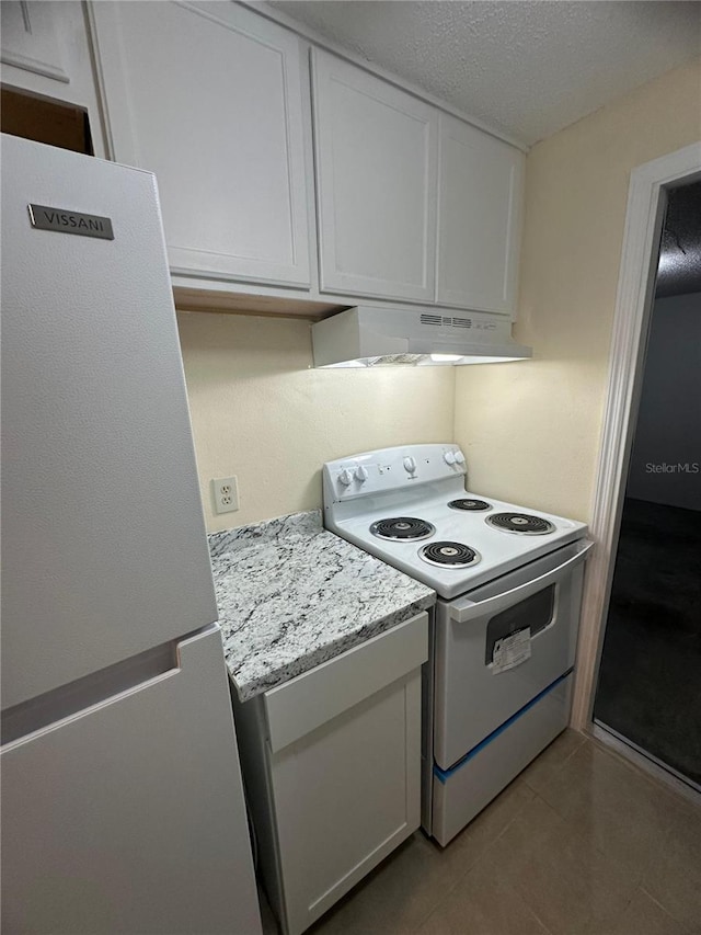 kitchen featuring a textured ceiling, white refrigerator, electric range oven, and white cabinetry