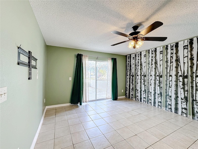 tiled empty room featuring ceiling fan and a textured ceiling