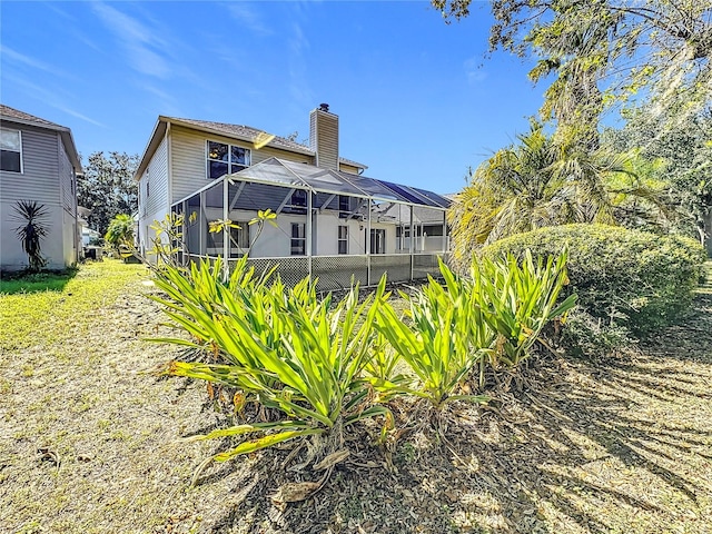 back of property with glass enclosure